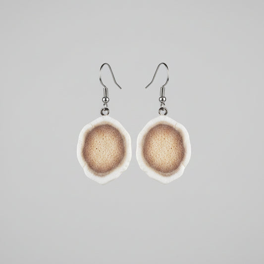Natural deer antler earrings on a gray background