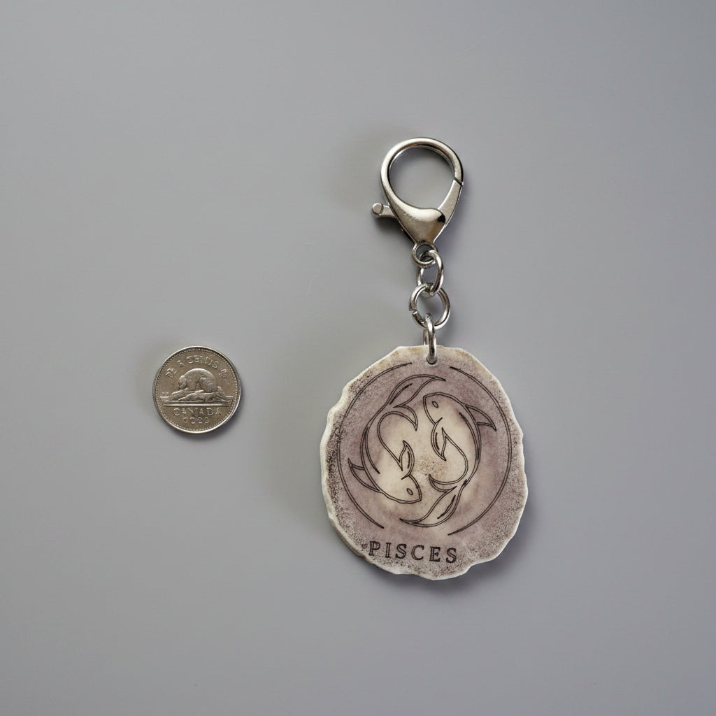 Moose antler zodiac sign keychain on a gray background