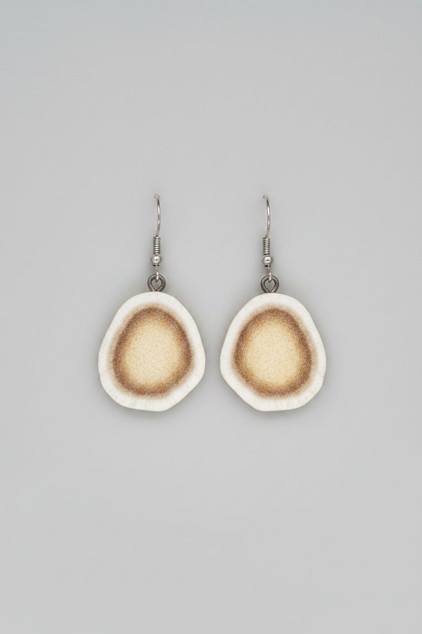 Natural deer antler earrings on a gray background