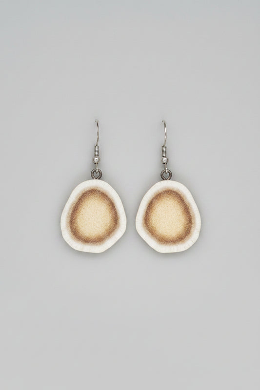 Natural deer antler earrings on a gray background
