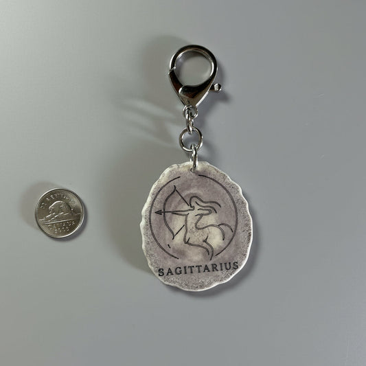 Moose antler zodiac sign keychain on a gray background
