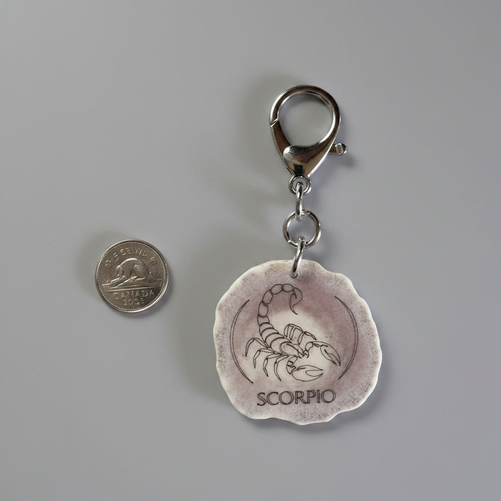 Moose antler zodiac sign keychain on a gray background