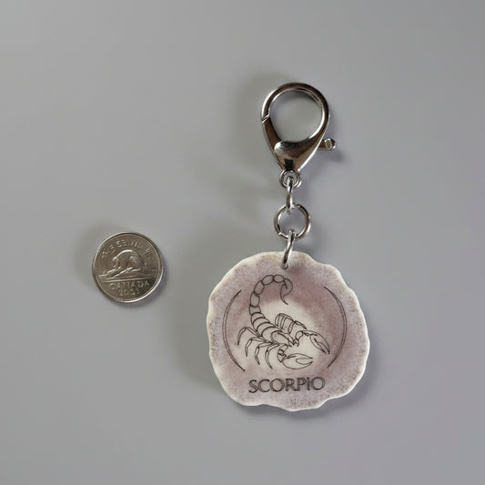 Moose antler zodiac sign keychain on a gray background