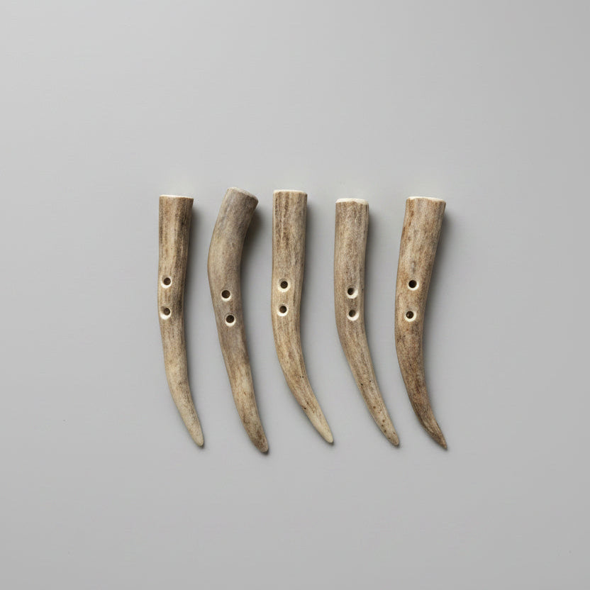 Deer antler toggle buttons on a gray background