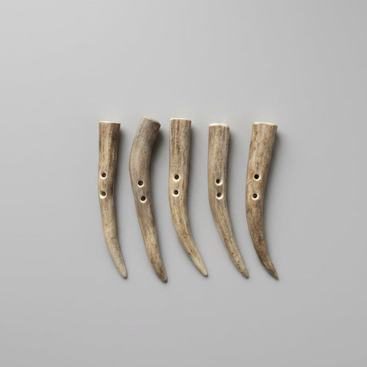 Deer antler toggle buttons on a gray background
