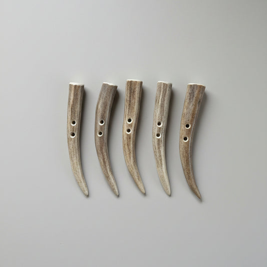 Deer antler toggle buttons on a gray background