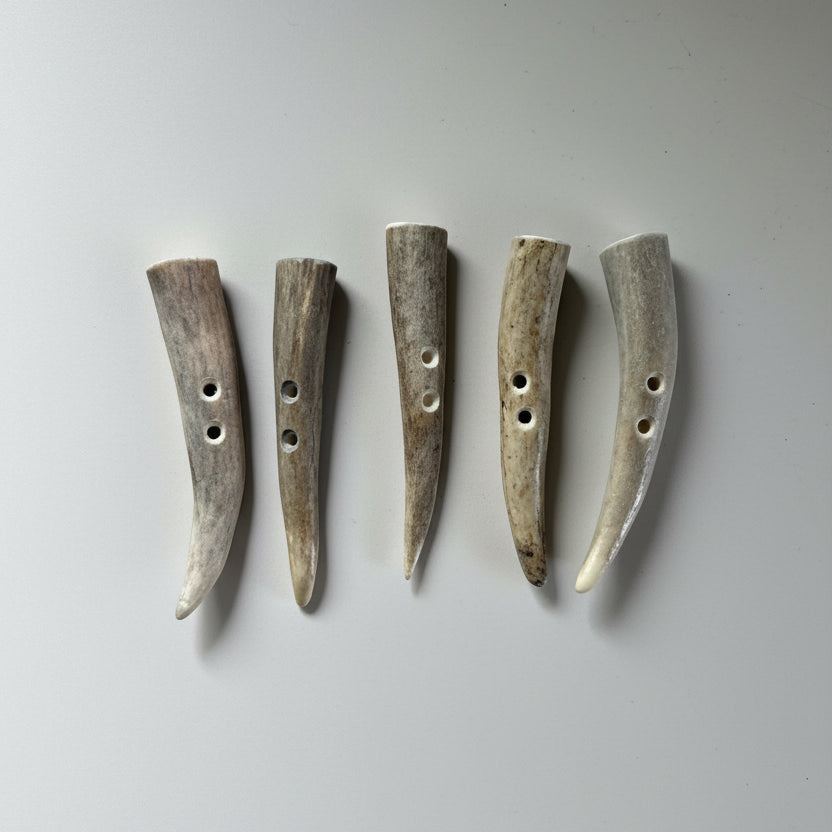 Deer antler toggle buttons on a gray background