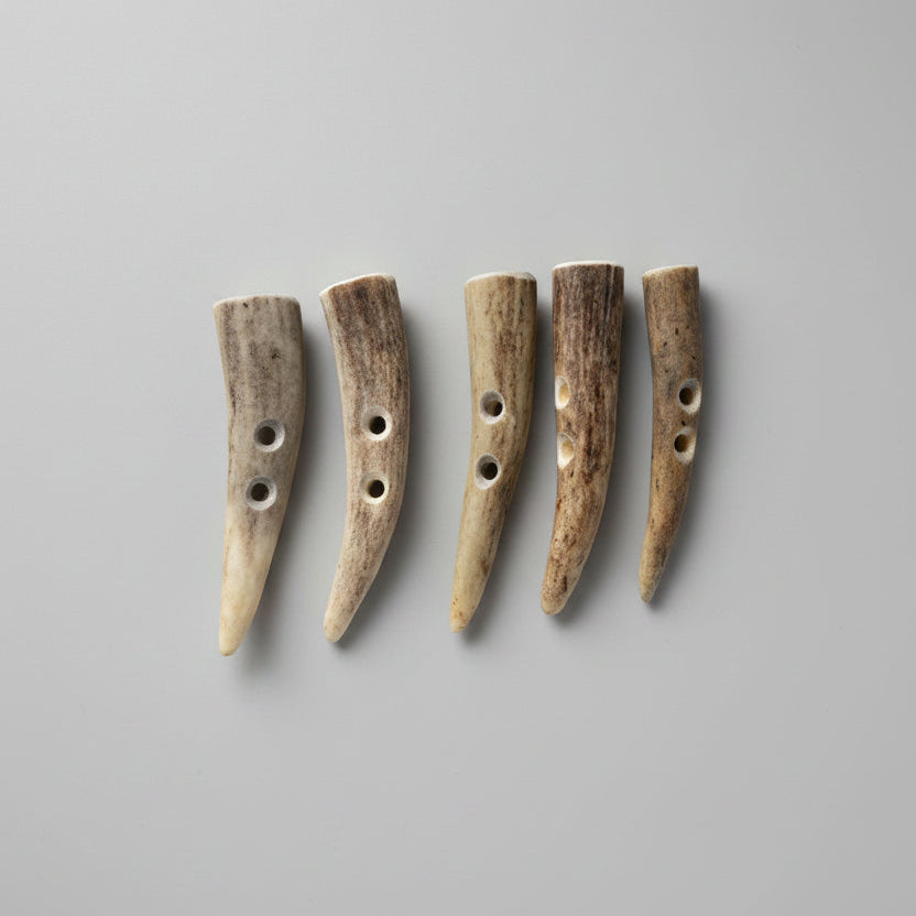 Deer antler toggle buttons on a gray background
