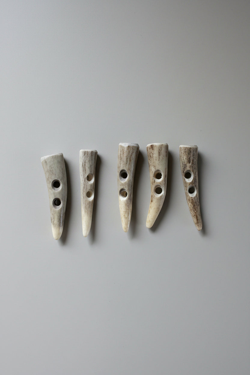 5 Deer antler toggle buttons on a gray background