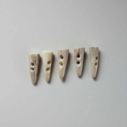 5 deer antler toggle buttons around 1 inch long on a gray background