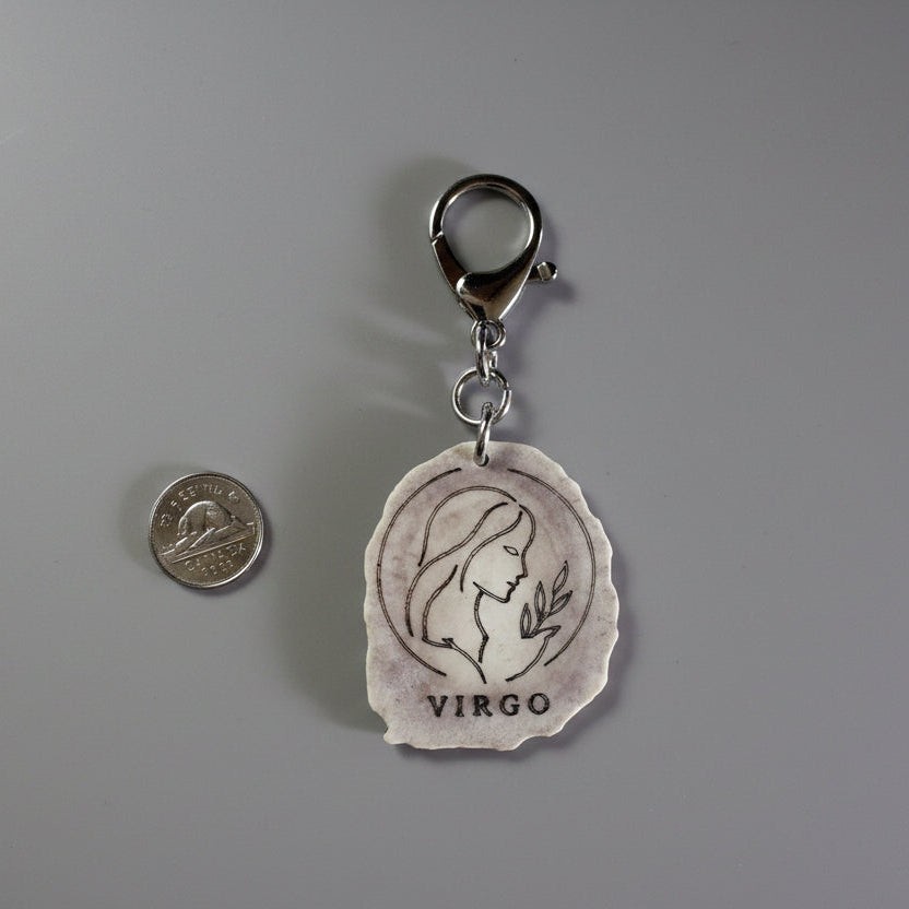 Moose antler zodiac sign keychain on a gray background