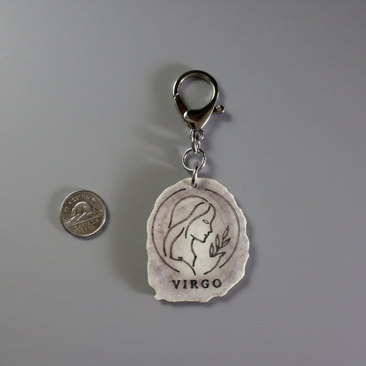 Moose antler zodiac sign keychain on a gray background
