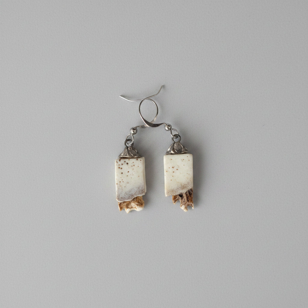 Elk earrings on a gray background
