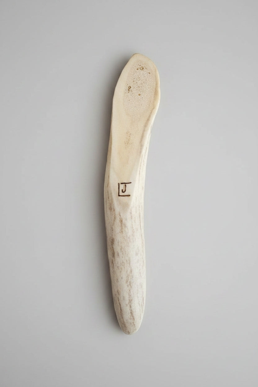Bottom view of the Natural deer antler aroma diffuser piece on a gray background